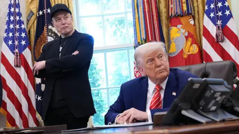 Getty Images Tesla CEO Elon Musk and U.S. President Donald Trump listen to a question from reporters in the Oval Office of the White House on May 30, 2025 in Washington, DC
