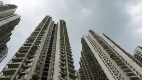 BBC/ Gavin Butler High-rise apartment buildings in Forest City seen from below