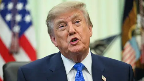 AFP via Getty Images A close up shot of President Donald Trump speaking at the Oval Office.