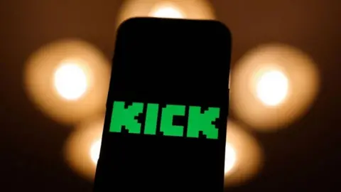 Getty Images A phone screen shows the word "Kick", green and in a pixellated font.