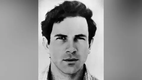 GPO via Getty Images A black and white portrait photograph of Yonatan Netanyahu. Blurred grey bars are either side of the photo. 