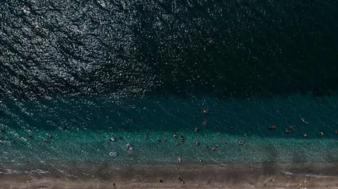 Getty Images Aerial view of strip of beach in Greece and ocean