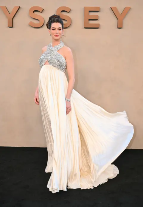 Getty Images Anne Hathaway in a flowing cream gown at The Odyssey premiere in New York