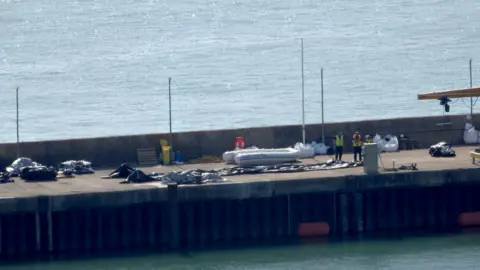 PA Media A deflated dinghy is seen on the quayside in Dover, Kent. A record 230 migrants arrived after crossing the Channel to the UK in a single boat on Monday