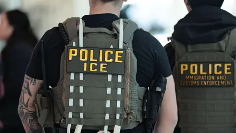 Getty Images Immigration and Customs Enforcement (ICE) agents patrol an airport