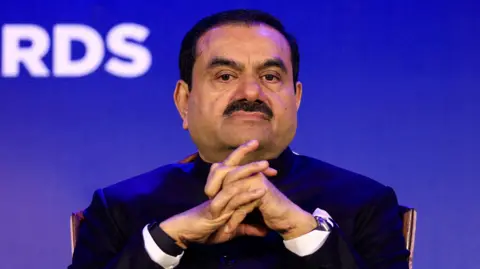 Reuters  Indian billionaire Gautam Adani - wearing a black coat and a white shirt - attends the 51st Gems and Jewellery Awards in Jaipur, India, November 30, 2024. 