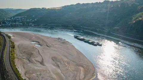 Getty Images An aerial view as a cargo ship passes a huge exposed sandbar on the Rhine River