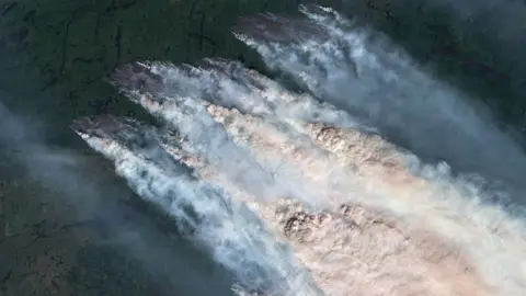 Gallo Images/Orbital Horizon/Copernicus Sentinel Data 2026 via Getty Images A satellite image showing wildfire smoke from fires in Northwestern Ontario in July. 