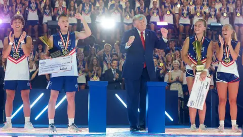 Getty Images Trump handed out cheques to the winners, and danced on stage alongside athletes