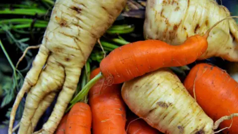 Getty Images A close-up of oddly shaped carrots and parsnips