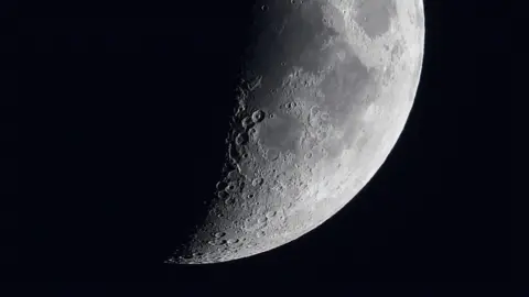 The Moon in part shadow, with craters showing
