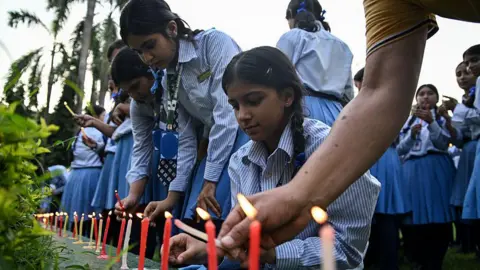 Getty Images Mourners and students light candles to offer their condolences after the death of mountaineer Nirmal Purja and his companions in an avalanche in Pakistan