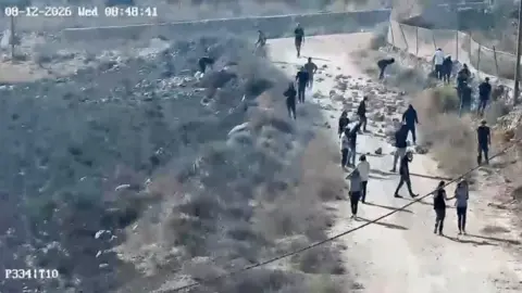 Settlers walk next to trees.