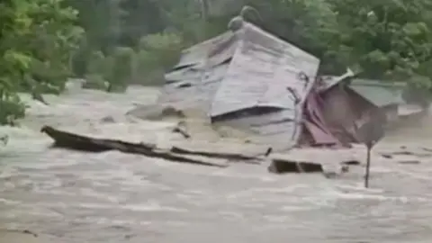 Flash flood tears down a mill.
