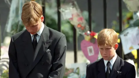 PA Media Prince William and Prince Harry bow their heads as their mother's coffin leaves her funeral service
