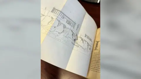 Catherine Taylor A folded-out page of a book with an illustration showing monuments in Greece