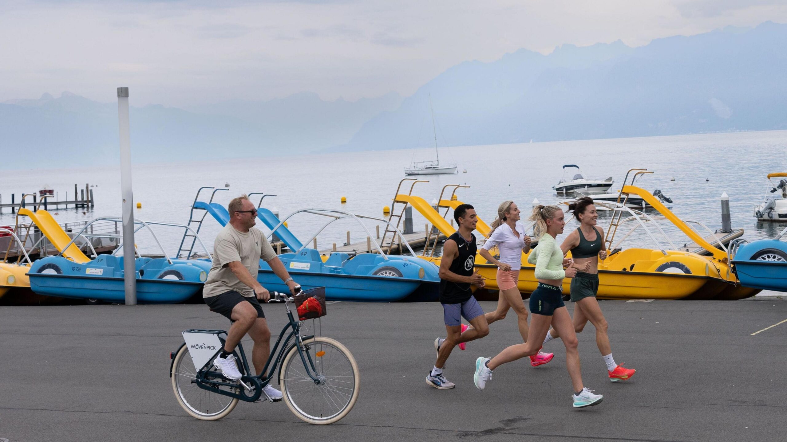Trevor Painter follows his M11 athletes on a bike during a training run before the Lausanne Diamond League meeting in 2025