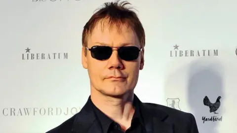 Getty Images William Orbit wearing dark glasses and looking at the camera in 2012