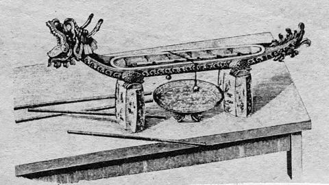 Alamy The balls hanging from thread on incense clocks would sound a small clang when the threads burned and they dropped into a metal tray below (Credit: Alamy)