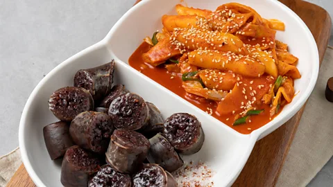 Alamy The spicy chewiness of tteokbokki pairs beautifully with savoury, crunchy foods like blood sausage (Credit: Alamy)