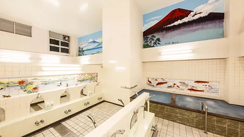 Konparu-yu A room in a bathhouse with pools and faucets, with wall murals of Mount Fuji and koi swimming in a pond (Credit: Mizuki Uchiyama)  (Credit: Konparu-yu)